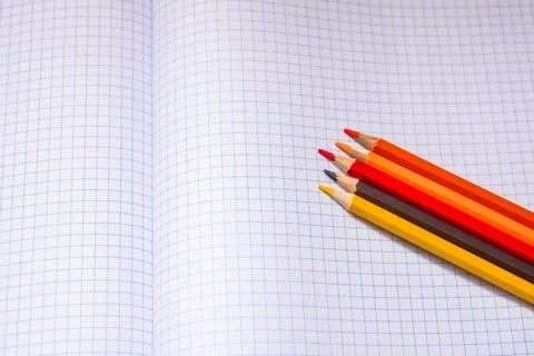 Colored pencils and a notebook Stock Photos