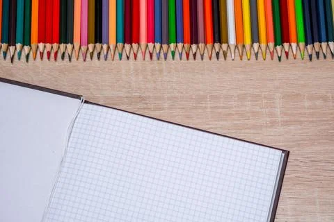 Colored pencils and a notebook Stock Photos