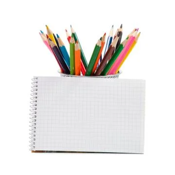 Colored pencils and an open notepad Stock Photos