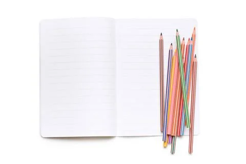 Colored pencils and open workbook colored pencils and open workbook on whi... Stock Photos