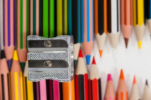 Colored pencils and sharpener on white background Stock-Fotos