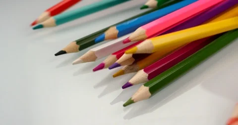 Colored pencils appear on white background. Close up view, shot on RED 6K camera Stock Footage 107915375