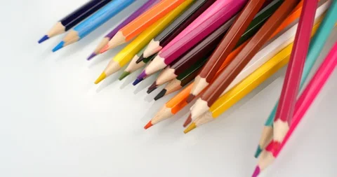 Colored pencils appear on white background. Close up view, shot on RED 6K camera Stock Footage 107916158