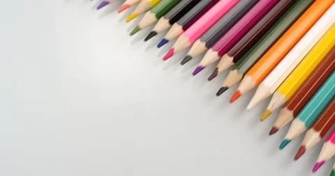 Colored pencils appear on white background. Close up view, shot on RED 6K camera Stock Footage 107917393