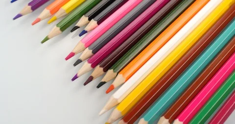 Colored pencils appear on white background. Close up view, shot on RED 6K camera Stock Footage 107917900