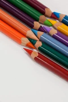 Colored pencils arranged in interlock pattern on white background 写真素材