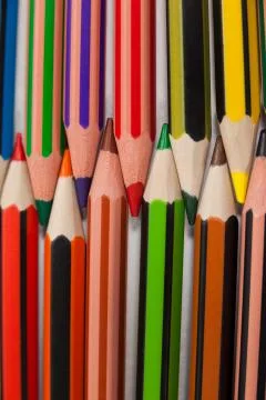 Colored pencils arranged in interlock pattern on white background 스톡 사진