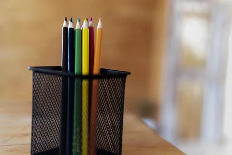 Colored pencils in the basket Stock Photos