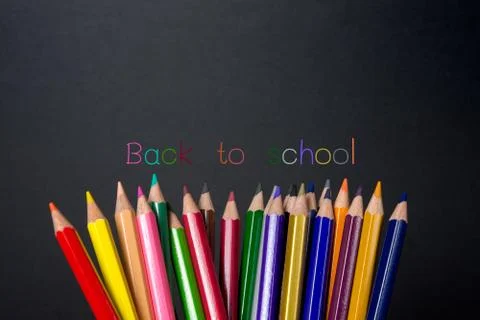 Colored pencils on blackboard  background with "Back to school" text , back t Foto stock