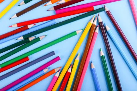 Colored pencils, on blue background, pattern, copy space. Foto stock