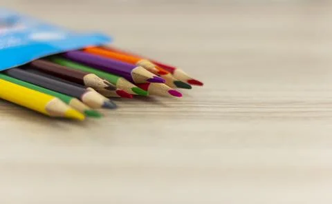 Colored pencils in a box on the table. Stock Photos