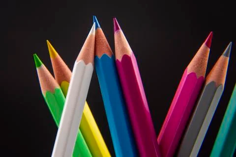 Colored pencils for drawing on a dark background. Education and creativity. L Stock Photos