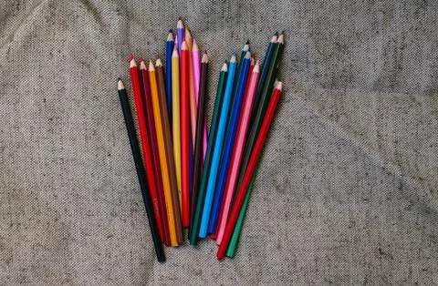 Colored pencils on grey background Foto stock