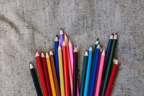 Colored pencils on grey background Foto stock