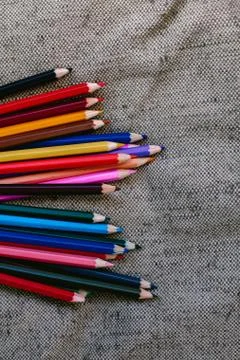 Colored pencils on grey background Stock Photos