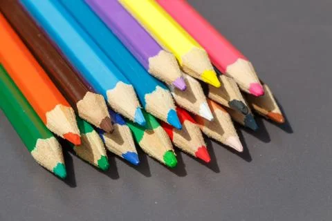 Colored pencils on grey background Foto stock