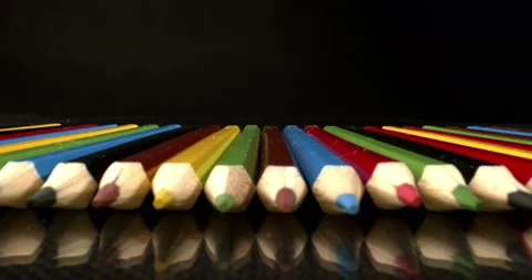 Colored pencils lie in an even row on glossy table. Good for art school Video stock 146734849
