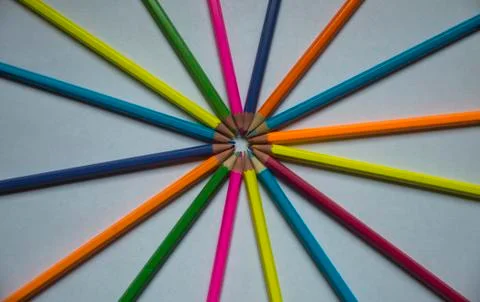 Colored pencils lined on a white sheet of paper Stock Photos