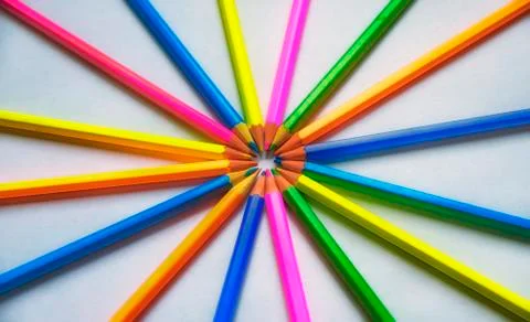 Colored pencils lined on a white sheet of paper Stock Photos