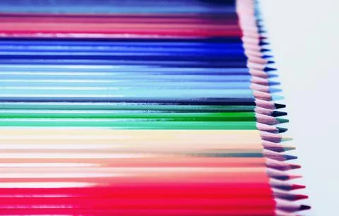 Colored pencils lying in row Stock Photos