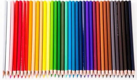 Colored pencils lying in row Foto stock