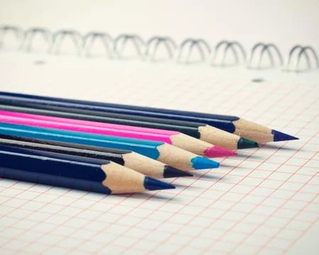 Colored pencils on notebook Stock Photos