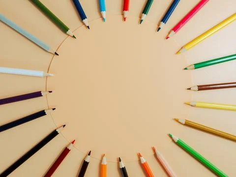 Colored pencils on an orange background. 스톡 사진