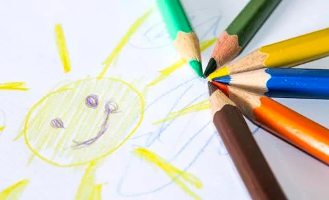 Colored pencils with painted sun Stock Photos