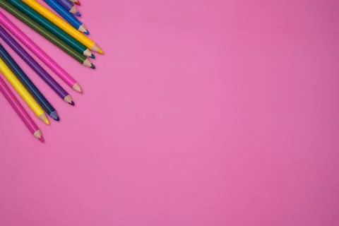 Colored pencils on pink background Stock Photos