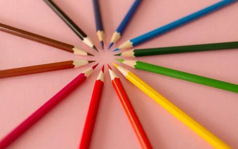 Colored pencils on a pink background with space for text Stock Photos