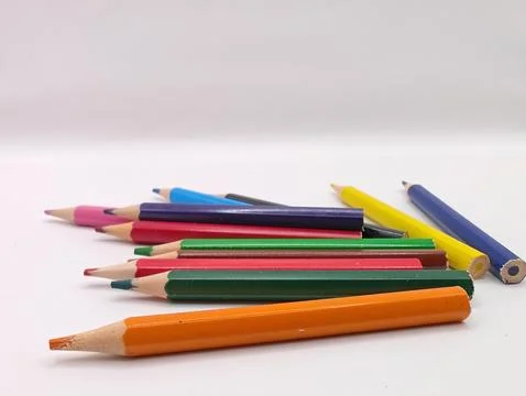 Colored pencils randomly on the background Stock Photos