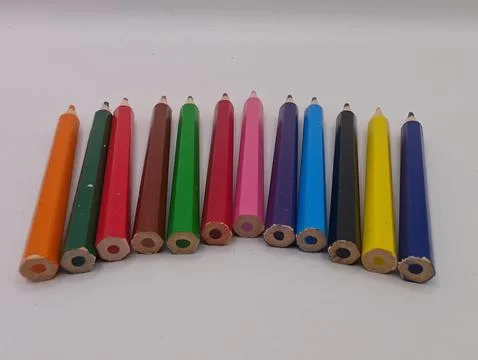 Colored pencils randomly on a white background Stock Photos