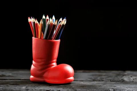 Colored pencils in a red boot on Stock Photos