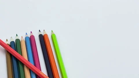 Colored pencils rolling in from the left Stock Footage 194006523