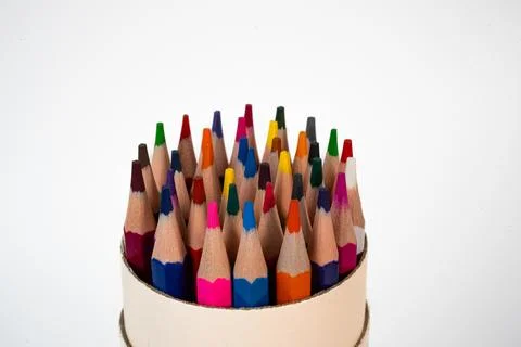 Colored pencils in round cup isolated on white background Stock Photos