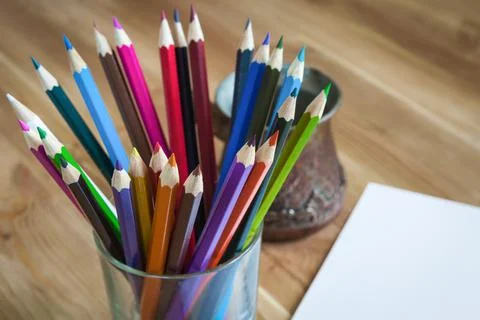 Colored pencils on the table in different combinations and proportions Stock Photos