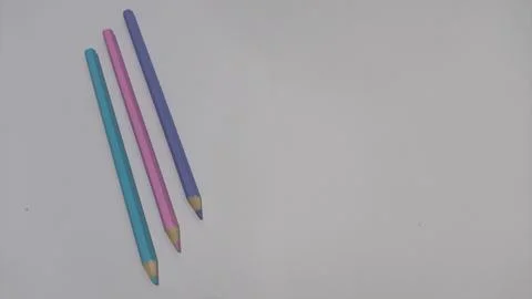 Colored pencils on white background with copy space Stock Photos