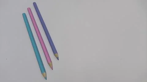Colored pencils on white background with copy space Stock Photos