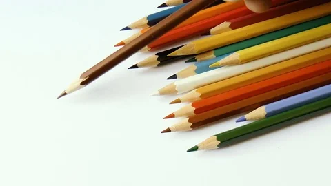 Colored pencils on white paper Stock Footage 79099653
