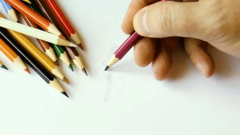 Colored pencils on white paper Stock Footage 79276818