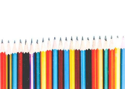 Colored pencils on white table, back to school education concept background. Stock Photos