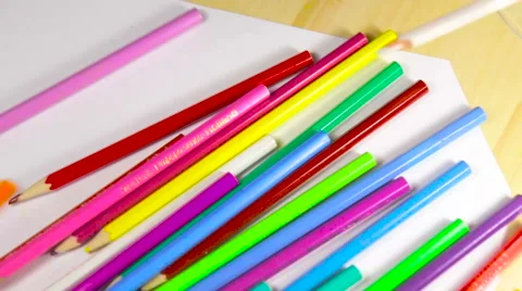 Colored pencils on white table dropped Stockbeeldmateriaal 65384655