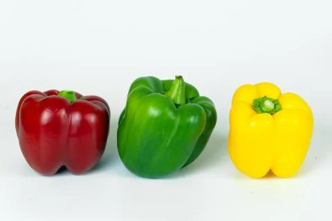 Colored peppers on a white background. Stock Photos