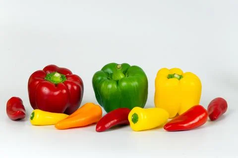 Colored peppers on a white background. Stock Photos