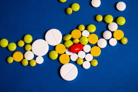 Colored pills on a blue background Stock Photos