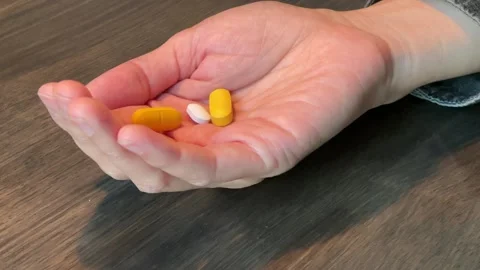 Colored pills falling on the table Видео 176619976