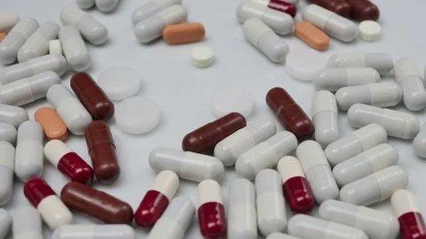 Colored pills rotating in the center side Stock Footage 81261404