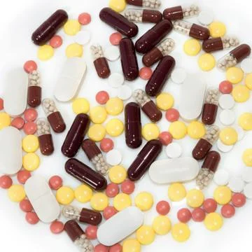 Colored pills on white Stock Photos