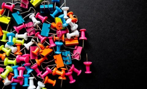 Colored pins on a black background close up Foto stock