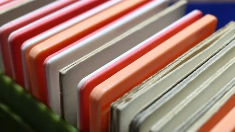 Colored plastic and cardboard frames with photographic film stand in a row one a Stock Footage 149220263